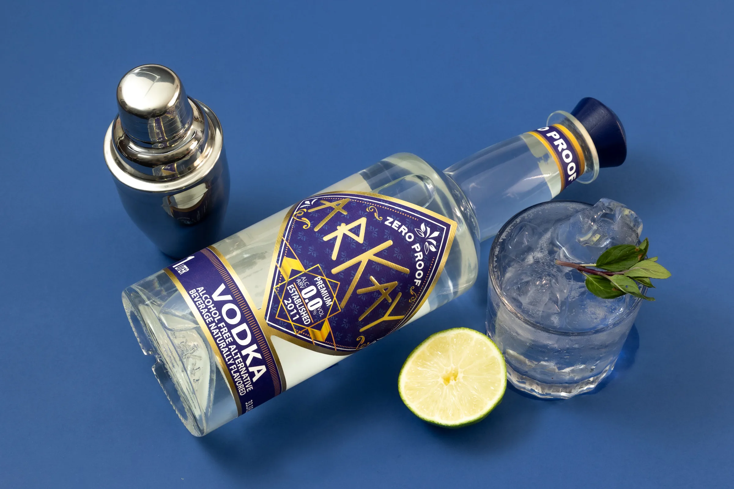 ARKAY vodka alternative with lime and a zero-proof mocktail on a blue background