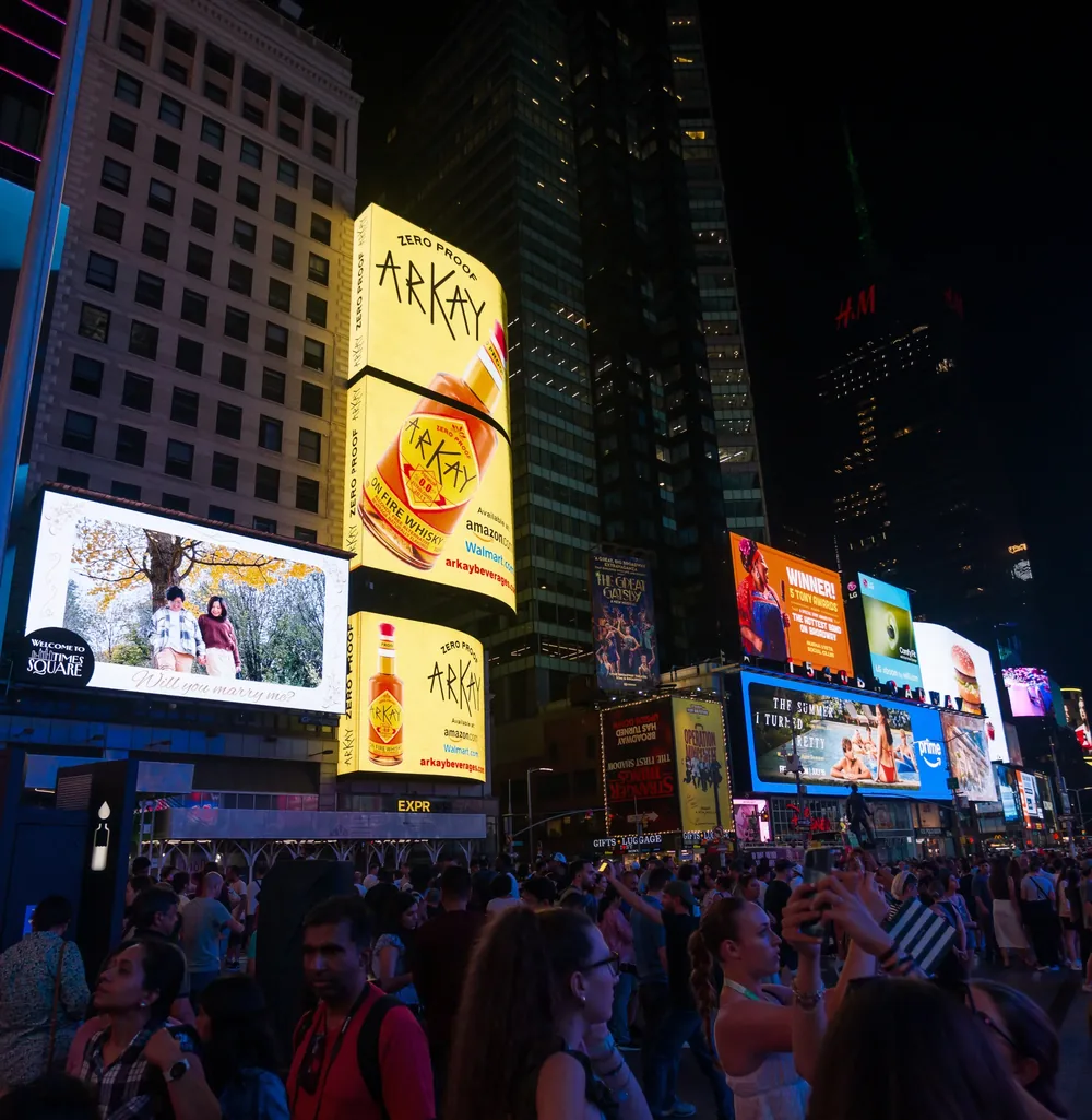 ARKAY zero-proof billboards lit up above the crowds in Times Square at night